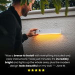 Una persona che installa una lampada a parete su una parete ruvida, con una didascalia che riporta una valutazione a cinque stelle.